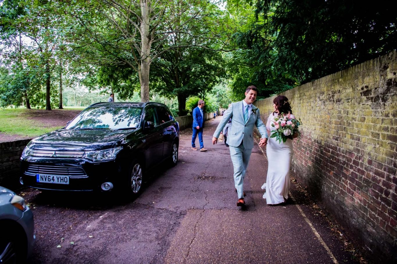 Bride groom walk to reception Petersham Village Hall